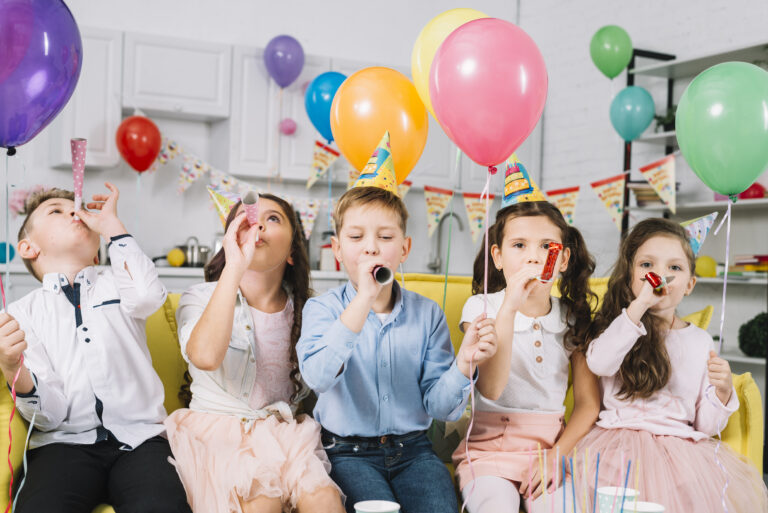 children-holding-colorful-balloons-blowing-party-horn-birthday